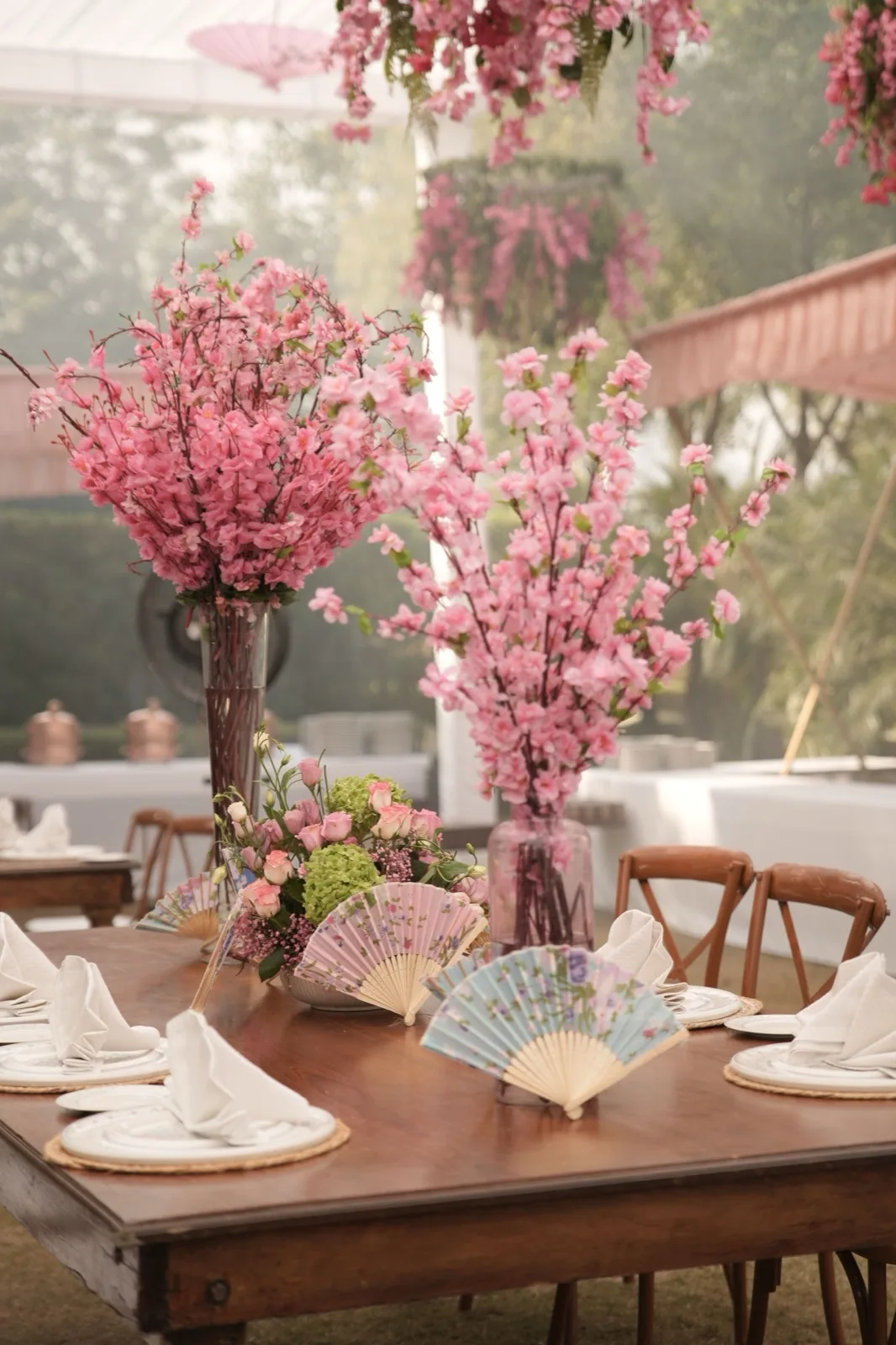 Pink cherry blossom table setting with fans