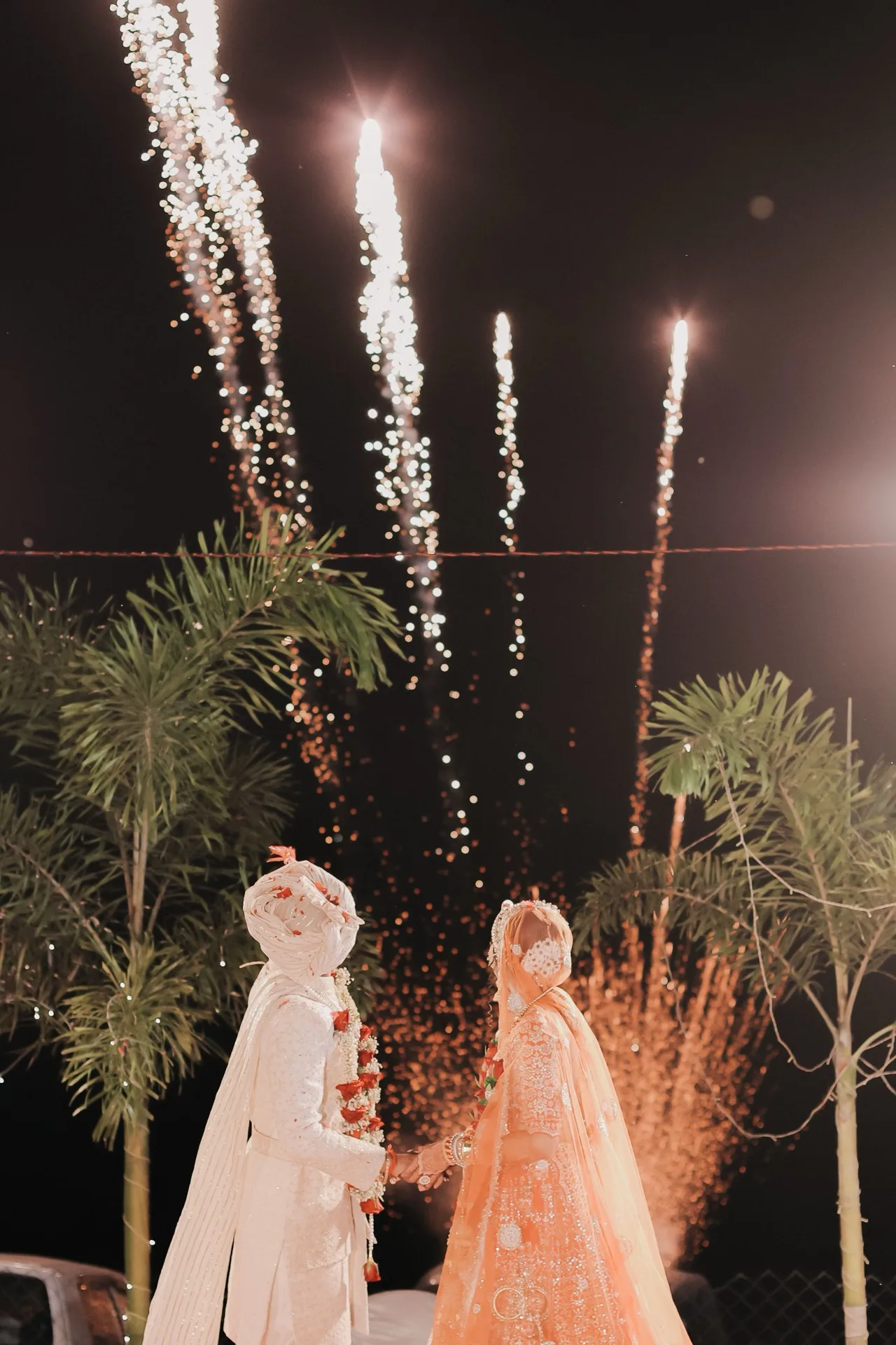 Bride and groom watching fireworks together