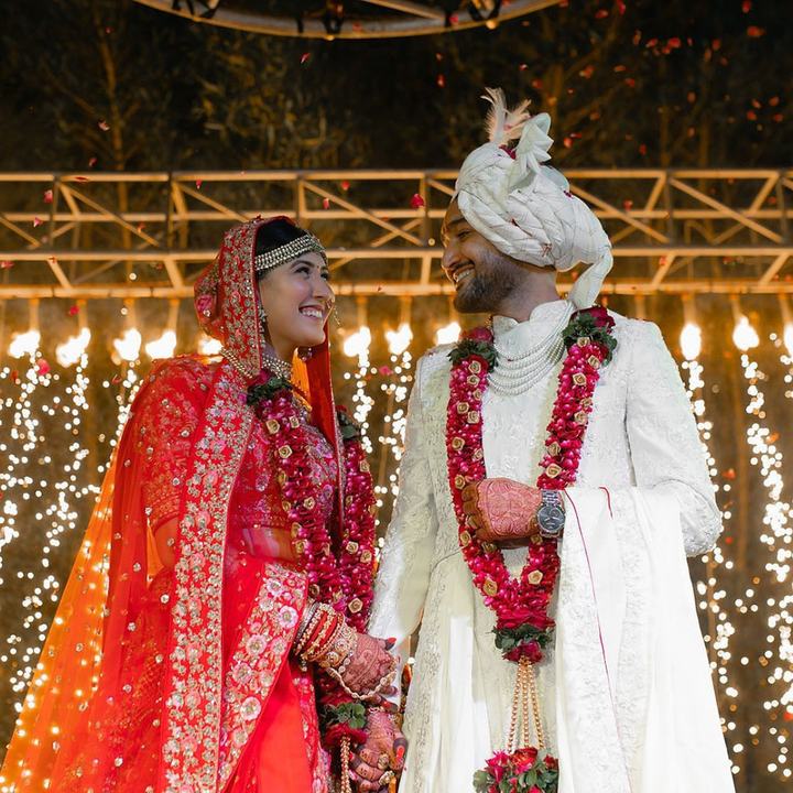 Bride and groom under a shower of flower petals