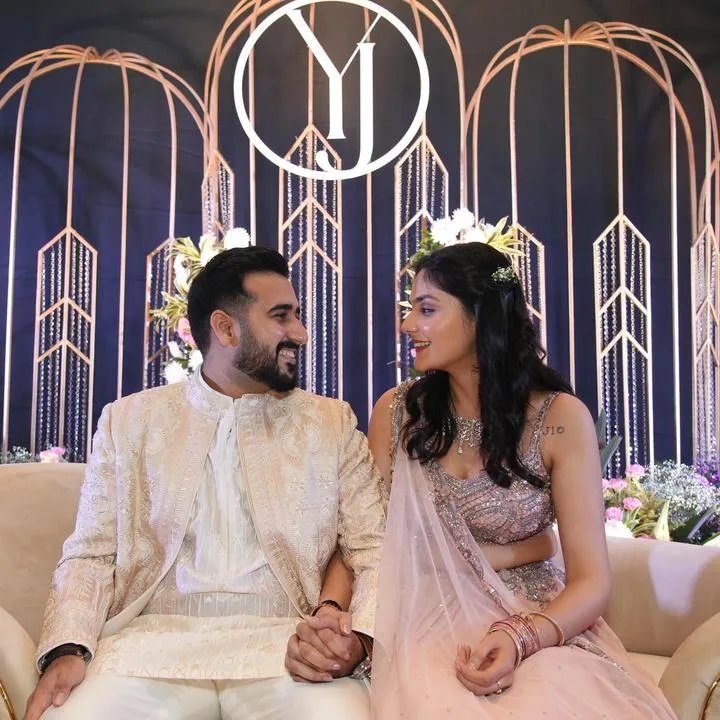 Bride and groom seated at their YJ wedding reception