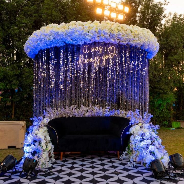 Blue crystal curtain backdrop with a neon sign