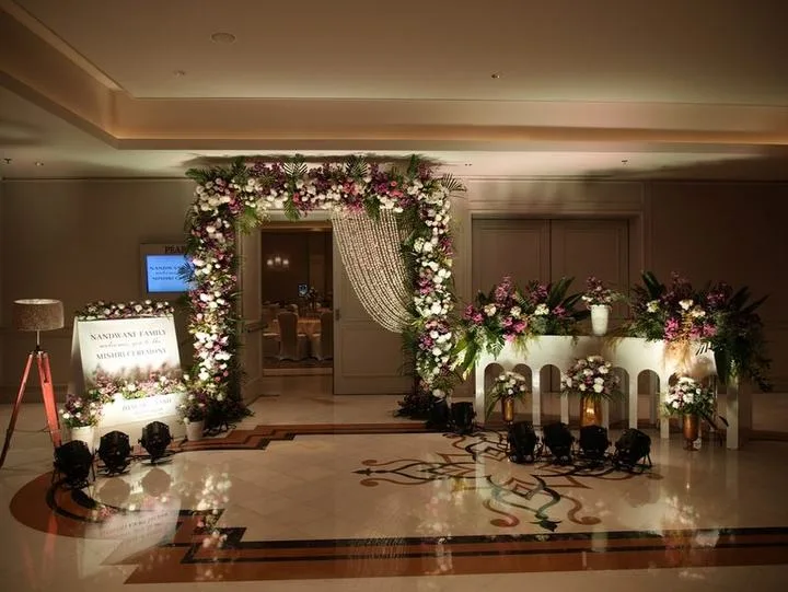 Floral entrance arch with hanging pearl strands