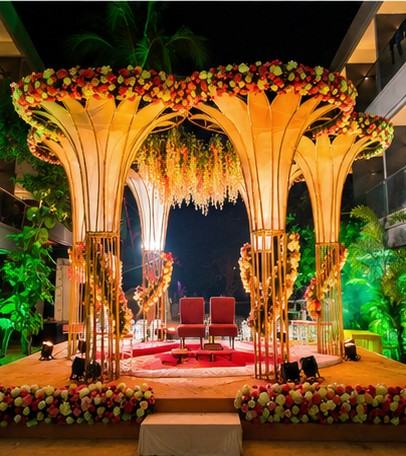 Golden floral mandap with hanging garlands
