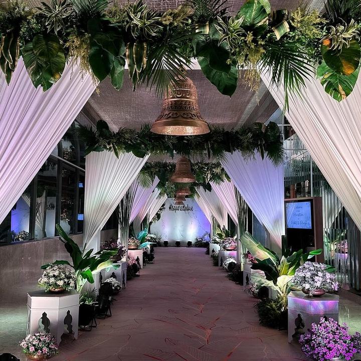 Green foliage entrance archway with hanging bells