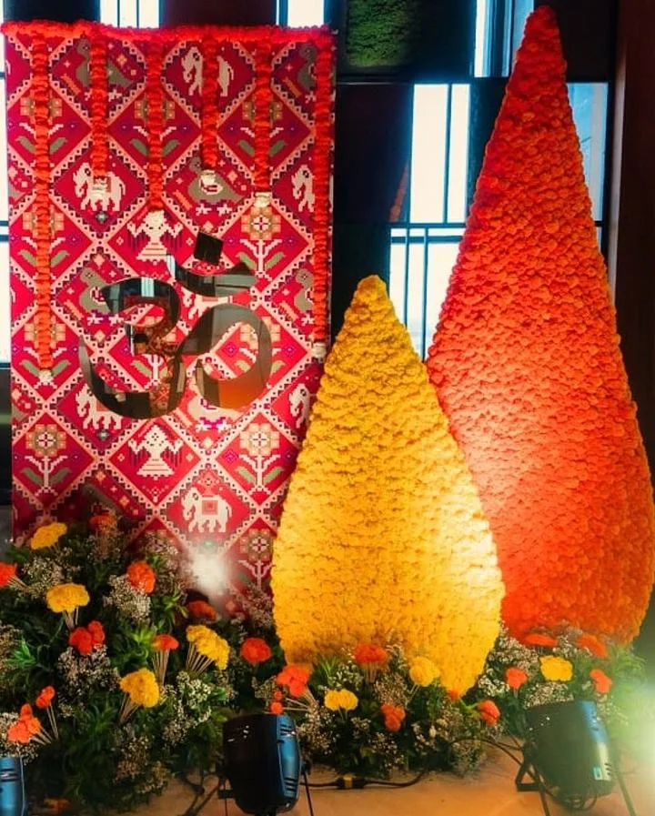 Rajasthani Om backdrop with marigold cone decor