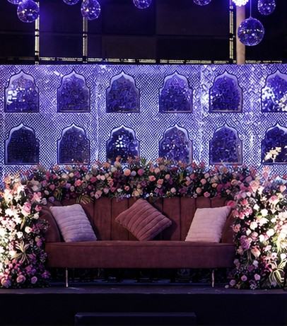 Mirror wall sangeet stage with floral sofa